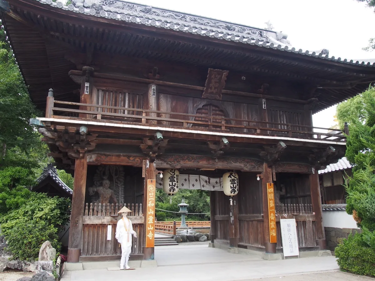 Ryozenji Temple gate in Bando, Naruto — the first of the 88 temples of the Shikoku Henro pilgrimage, with stone lanterns and morning mist