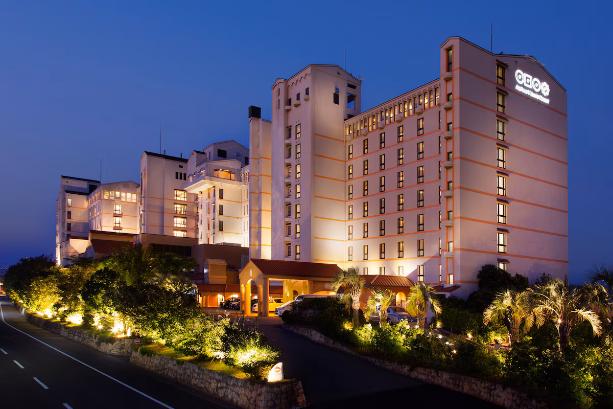 AoAwo Naruto Resort — Exterior architecture of AoAwo Naruto Resort at dusk, featuring the multi-story hotel towers and landscaped grounds in Tokushima.