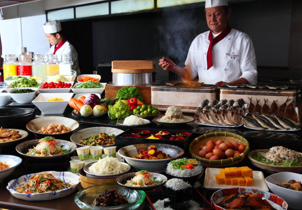 AoAwo Naruto Resort — breakfast buffet spread with a live cooking station, variety of seafood, fresh vegetables, and traditional Japanese cuisine.