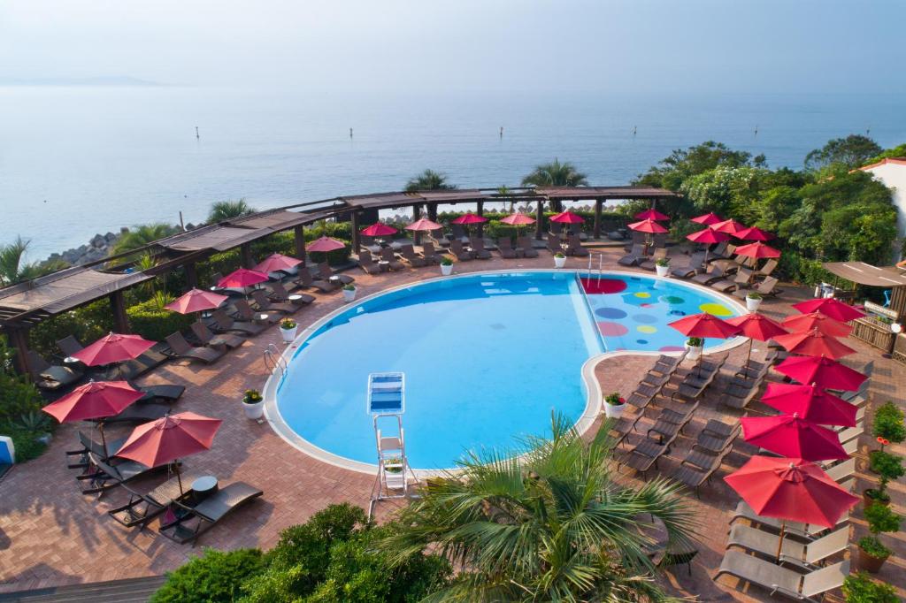 AoAwo Naruto Resort — circular outdoor pool and sun terrace with ocean views and tropical landscaping.