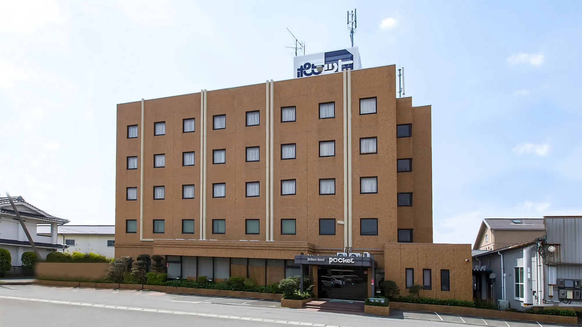 Business Hotel Pocket — exterior view of the budget hotel in Matsushige-cho, Tokushima Prefecture, positioned between Tokushima Airport and the Naruto Strait. | Hotel Manga