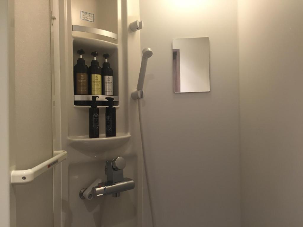 Grancustoma Ueno - Functional communal shower area in the Tokyo capsule hotel, Taito district.