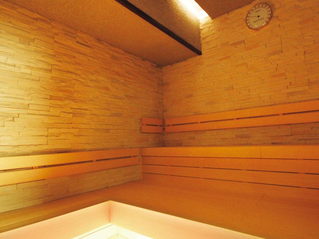 Grancustoma Ueno - Authentic dry sauna room with wooden benches and stone walls, Tokyo capsule hotel.