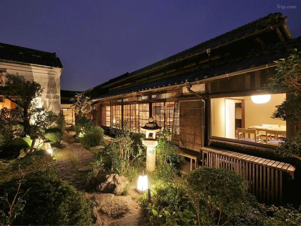 Hotel Cultia Dazaifu restored Meiji-era building exterior — sooty walls, traditional woodwork, Dazaifu shrine town