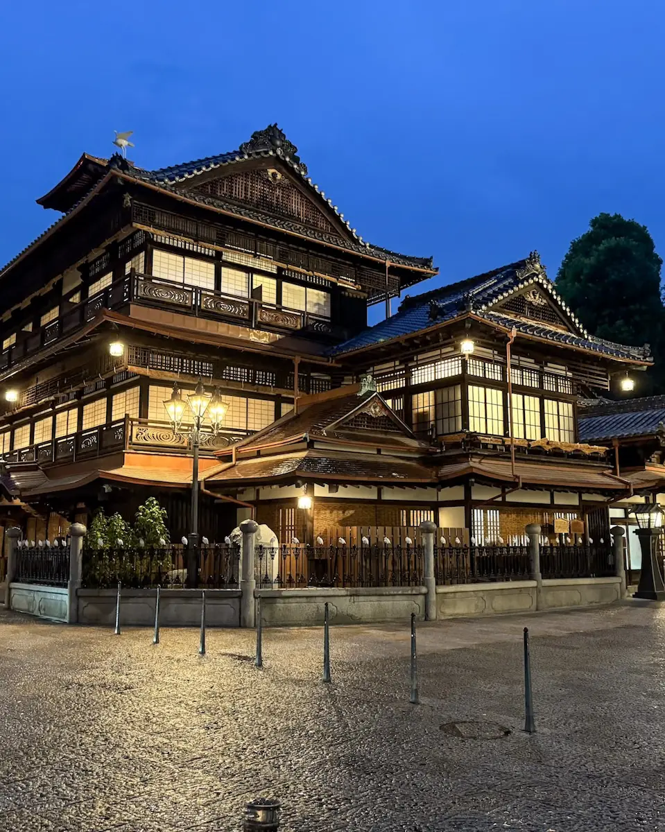 Dogo Onsen Honkan at night with lanterns