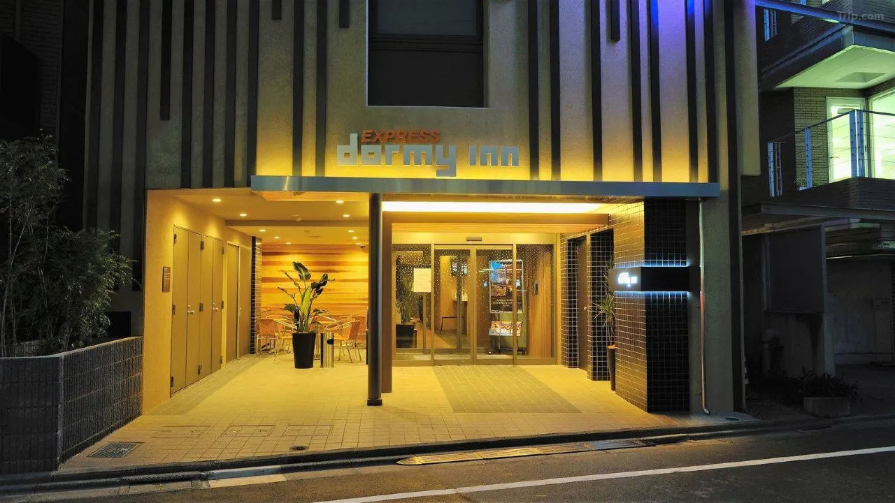 Meguro River cherry blossom tunnel in Nakameguro at night, Tokyo — pink sakura trees reflected in the canal
