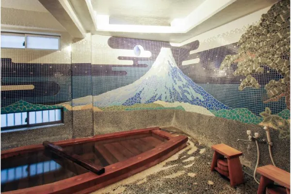 Traditional tatami guest room at Rekishi-no-Yado Kanaguya with carved wooden panels and tea set