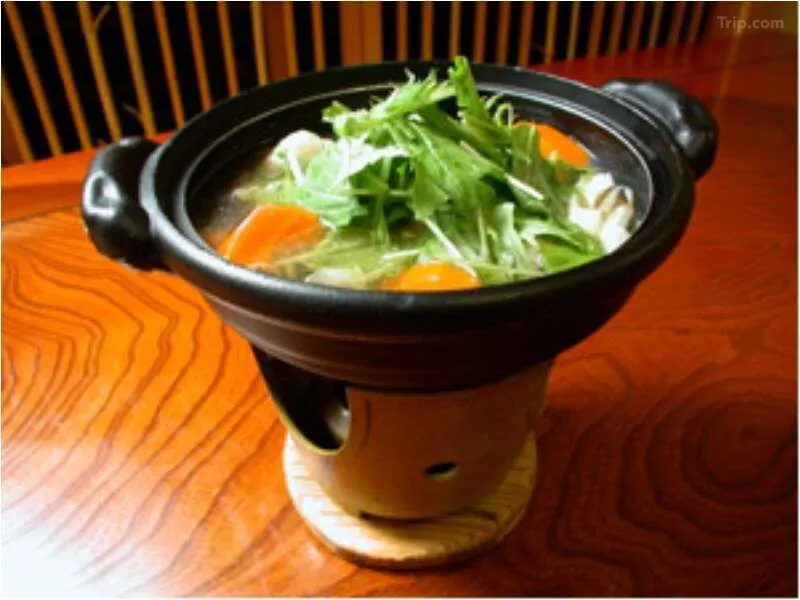 Interior curved staircase and lantern-lit corridor inside Kanaguya ryokan