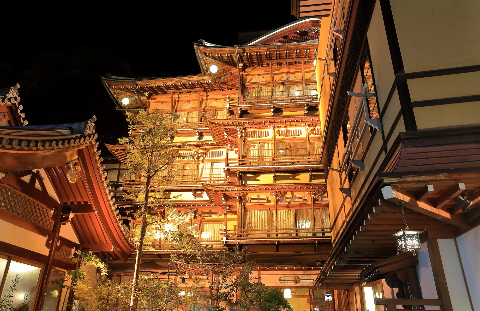 Rekishi-no-Yado Kanaguya Saigetsuro building illuminated gold at night, Shibu Onsen Nagano — the Spirited Away ryokan