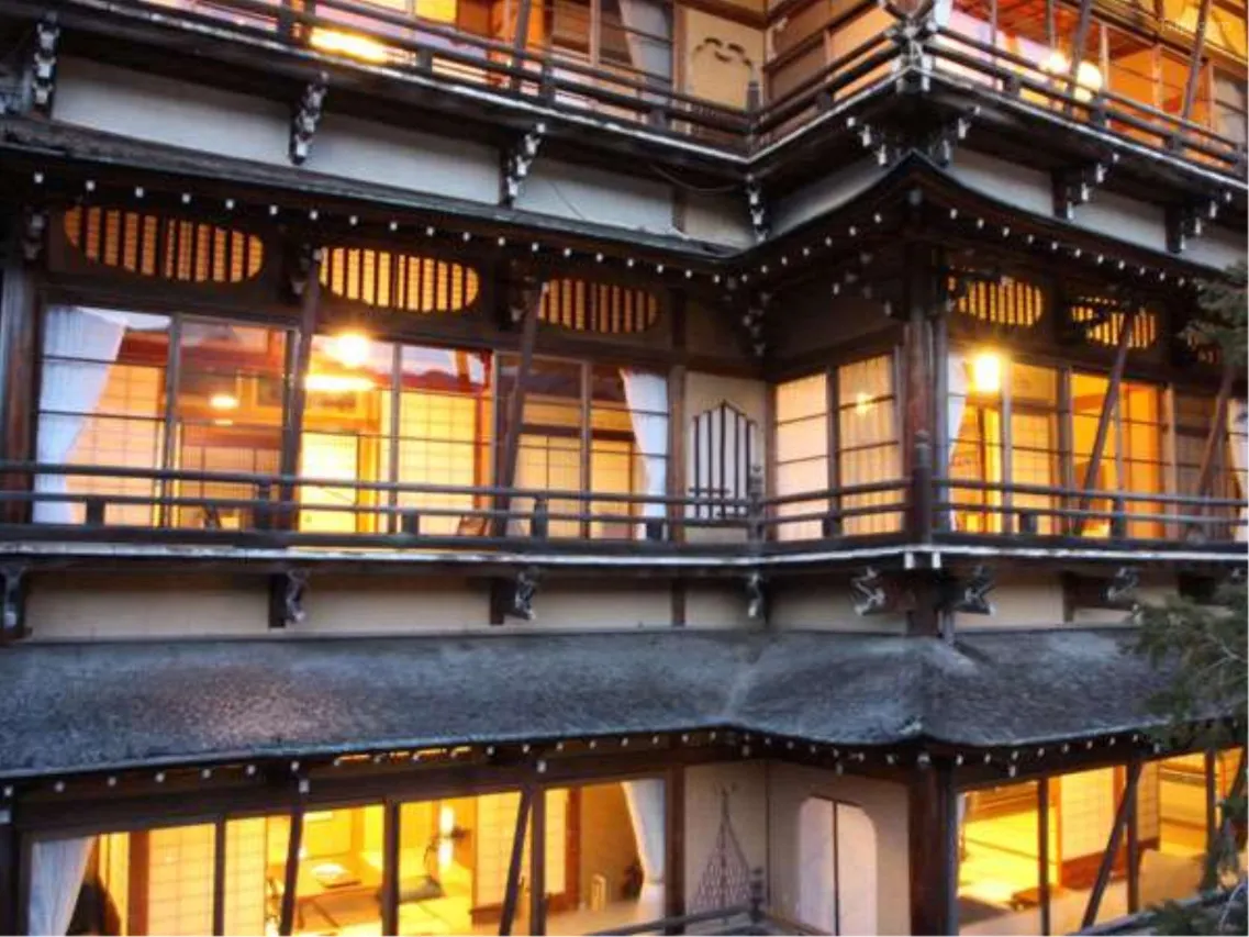Kanaguya Saigetsuro four-story wooden building exterior at dusk, Shibu Onsen Nagano — Tangible Cultural Property of Japan