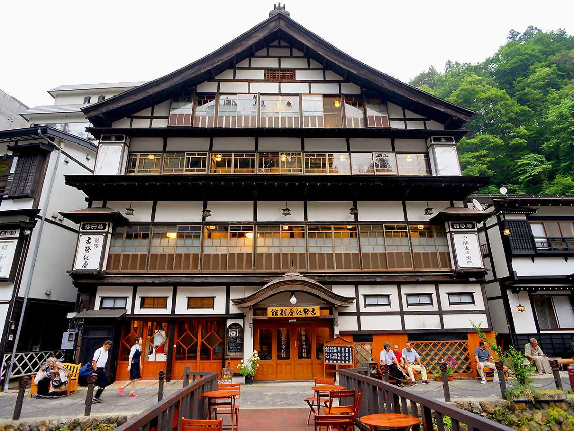 Kosekiya Annex exterior on the Ginzan River — Taisho-era timber architecture, gas lamps