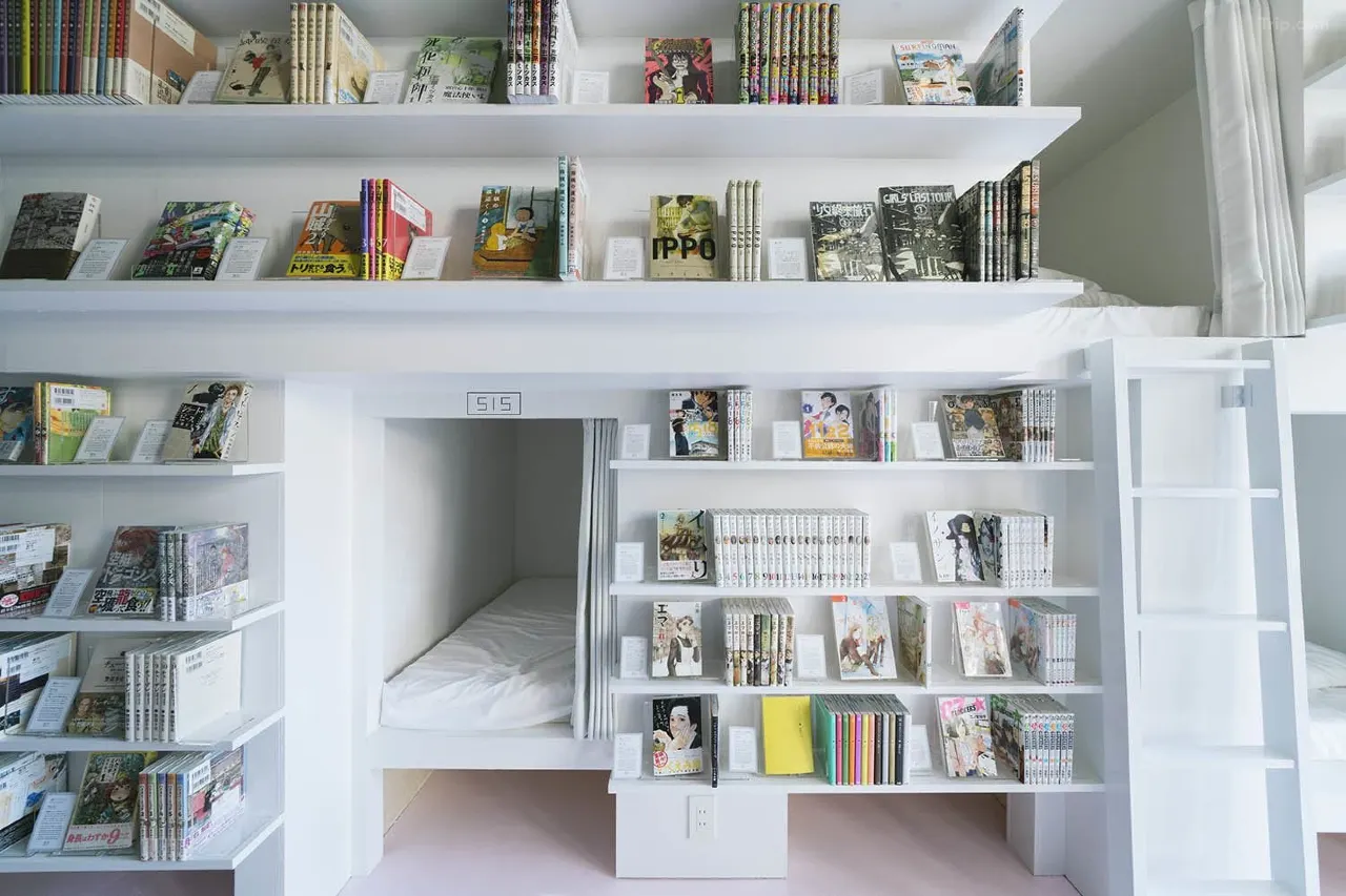 Manga Art Hotel Tokyo — capsule beds surrounded by manga shelves