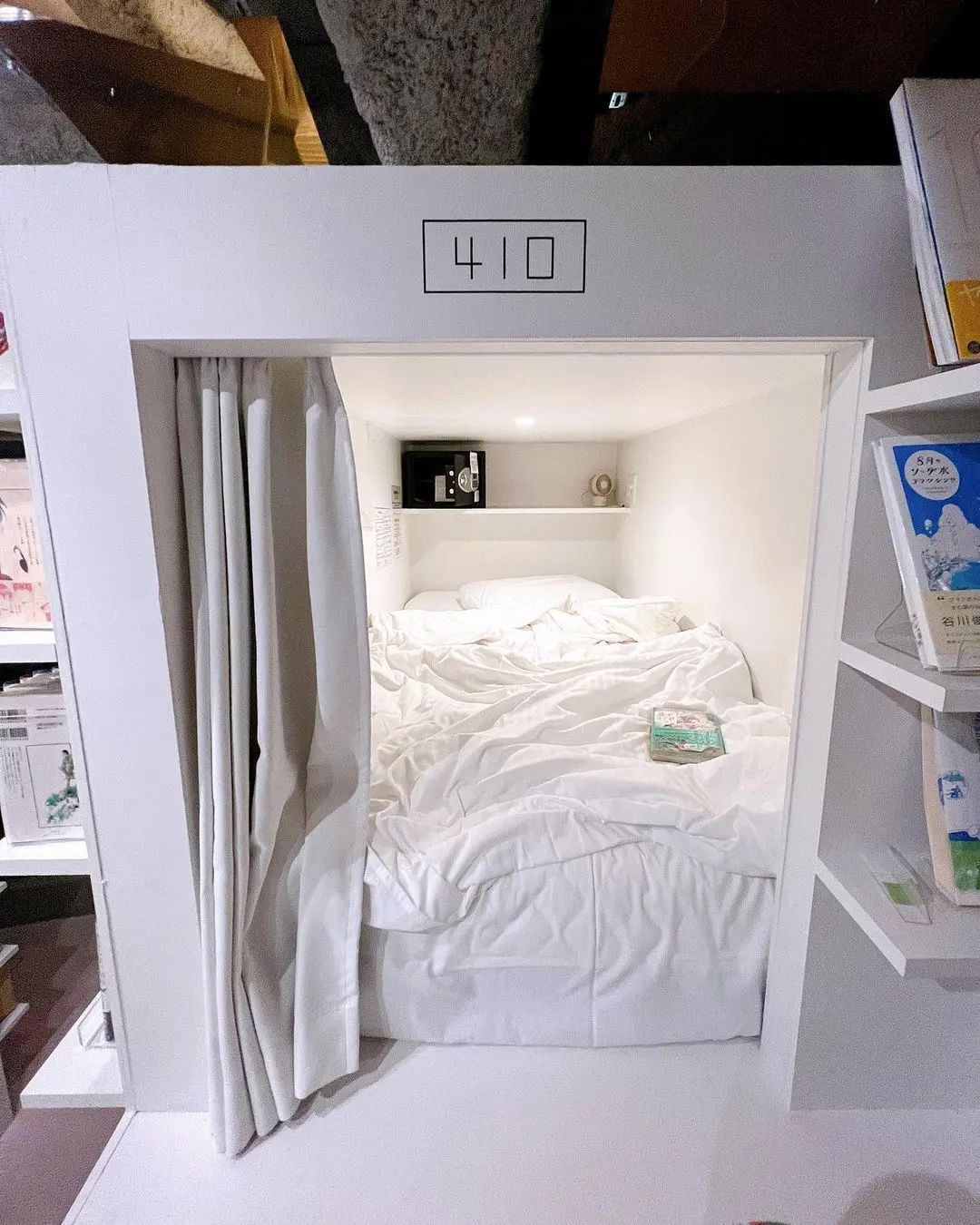 Capsule bed integrated into manga shelves at Manga Art Hotel Tokyo
