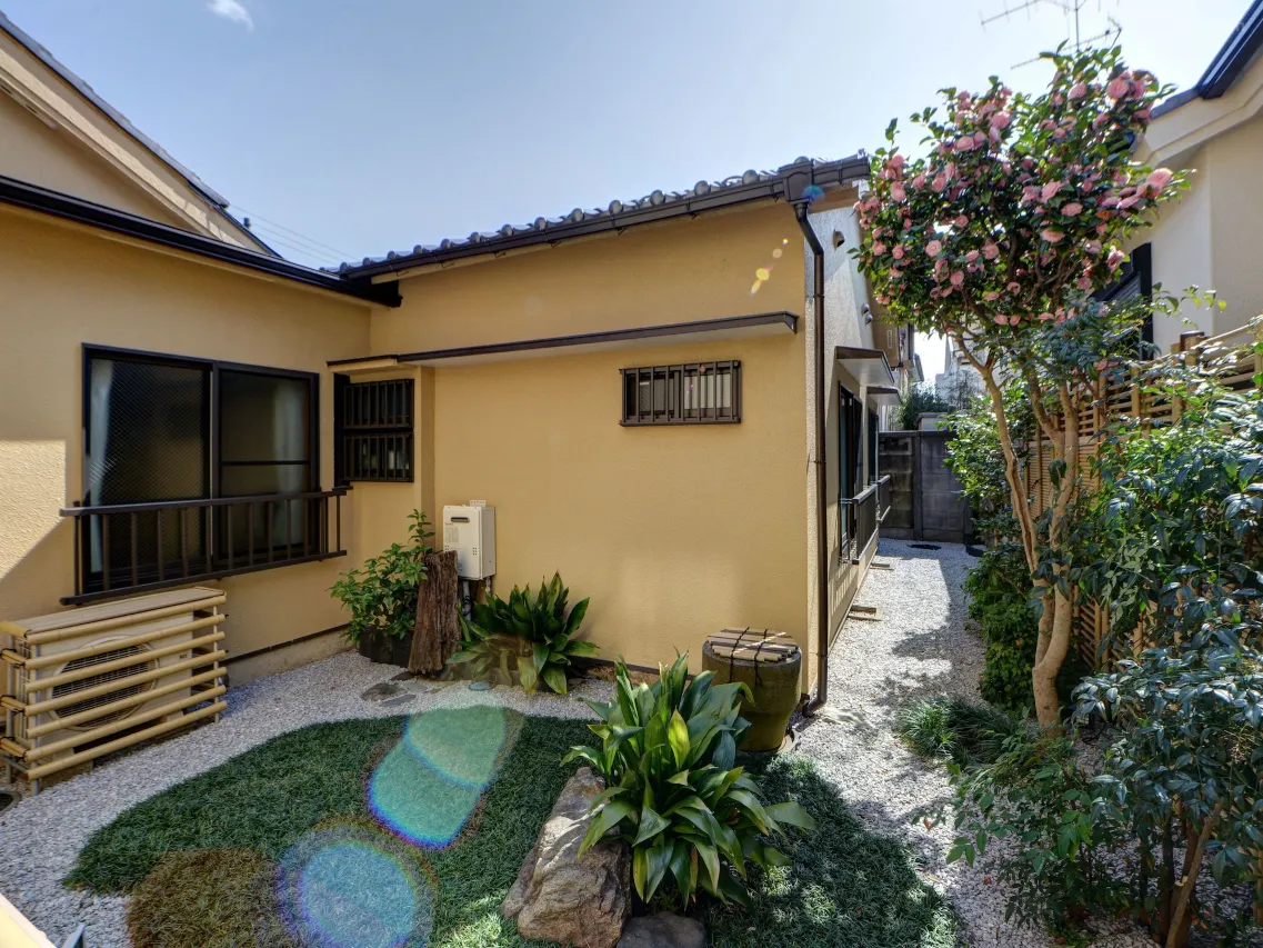 Ryokan Niko entrance with clay roof tiles and red umbrella, Musashi-Koganei Tokyo