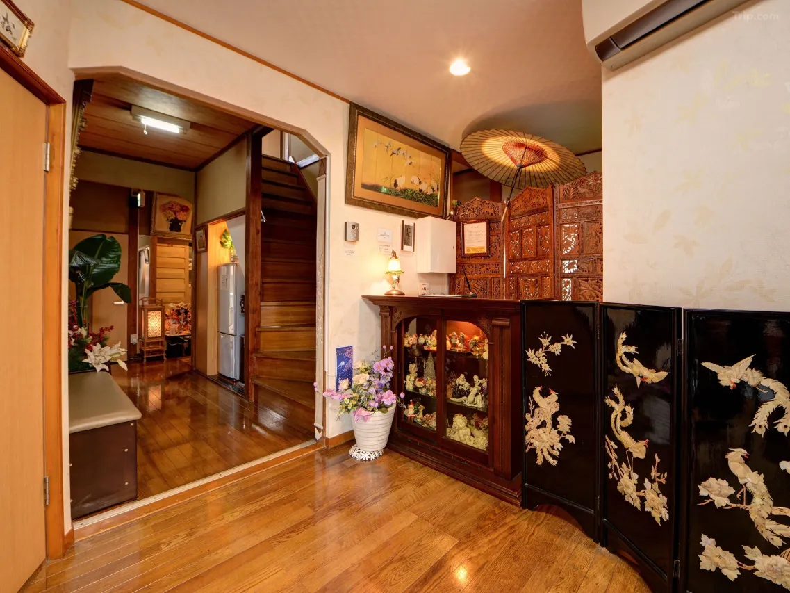 Ryokan Niko interior — polished hardwood corridor and Showa-era wooden details, Musashi-Koganei Tokyo