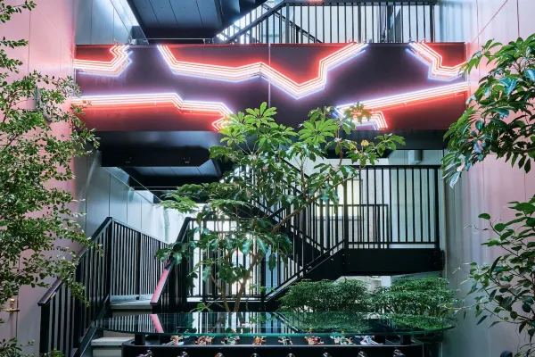 Nohga Hotel Akihabara atrium with neon artwork and foosball table