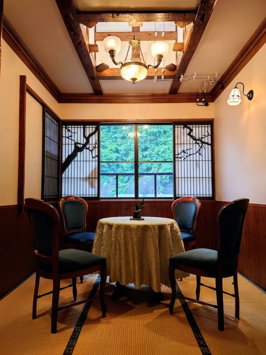 Ginzan Onsen street at dusk — gas lamps burning, snow on ryokan rooftops, river reflecting warm light