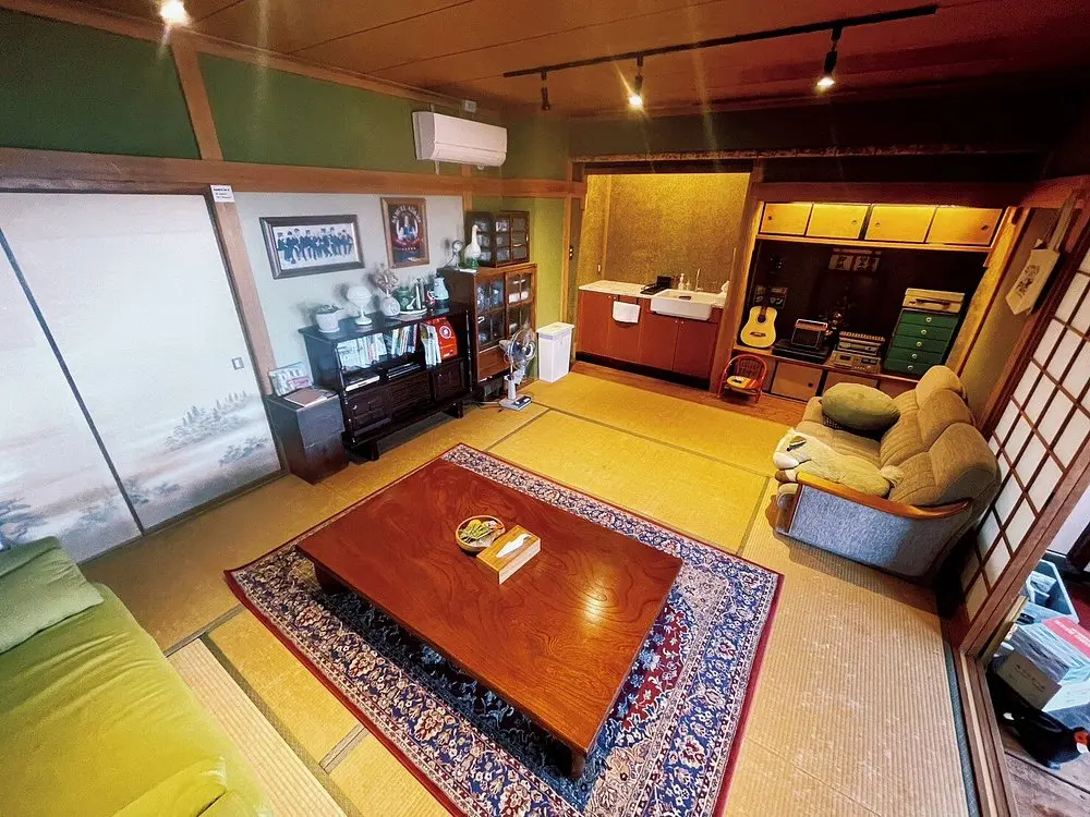 Yado Popeye exterior and Iyo-Kaminada Station with Seto Inland Sea in background