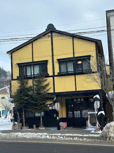 Sankosou 山湖荘 exterior in Nukabira Onsen Hokkaido — small traditional ryokan in Daisetsuzan birch forest